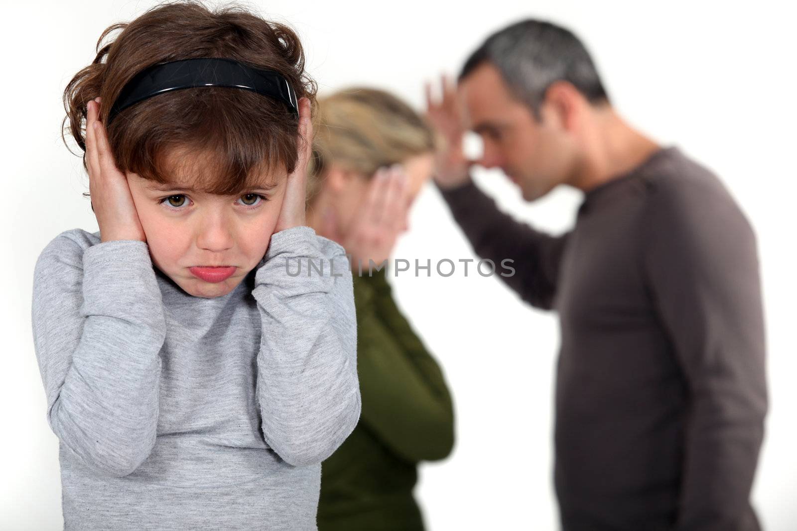couple having a quarrel in front of their little girl by phovoir