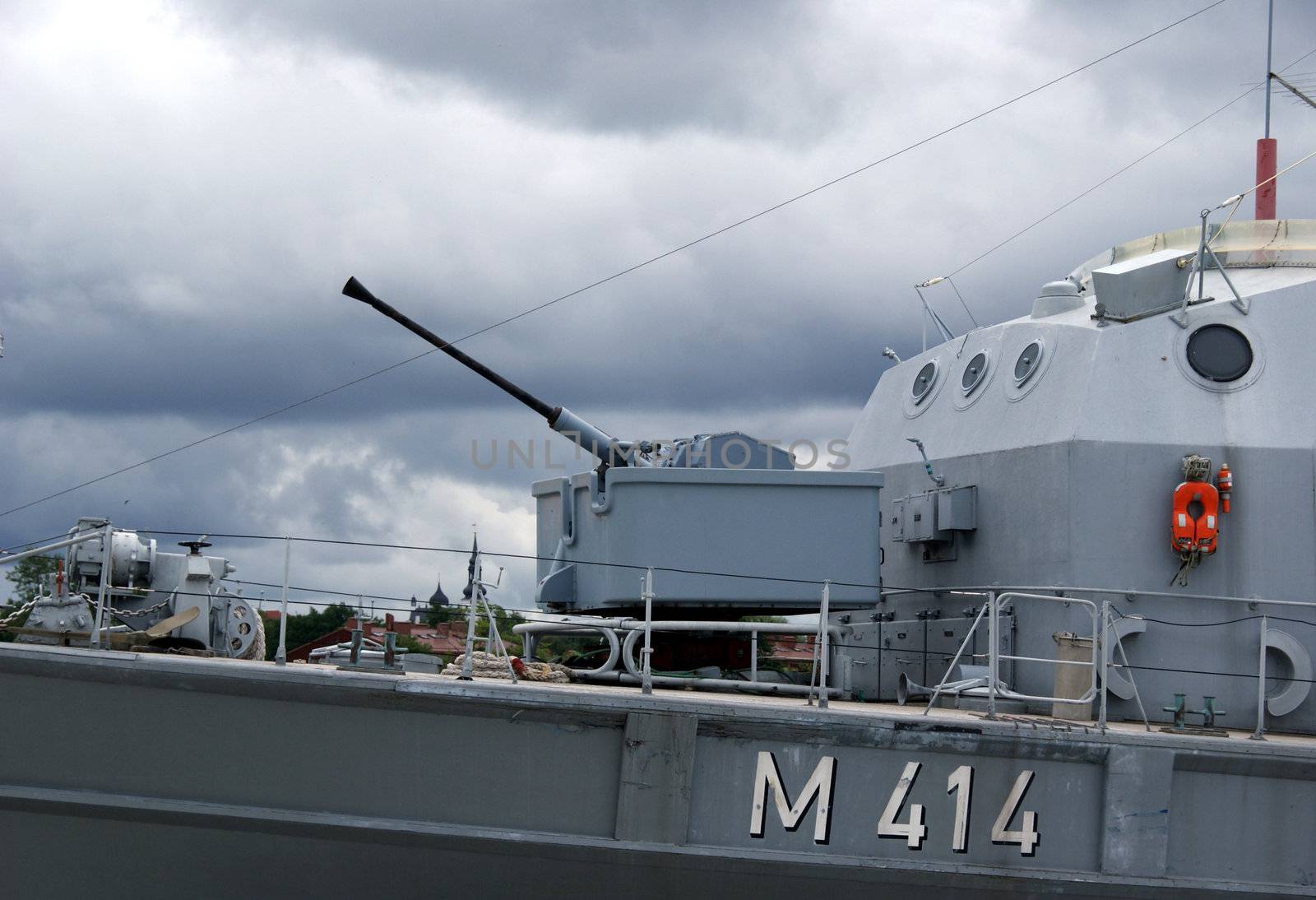 gun is on a military ship on deck