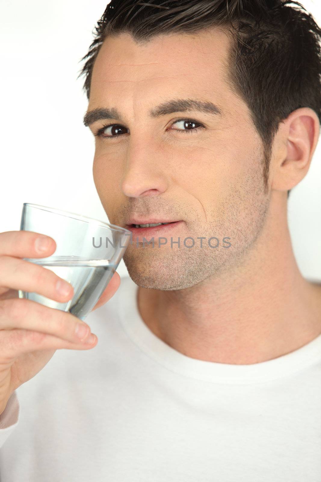 Man drinking a glass of water by phovoir