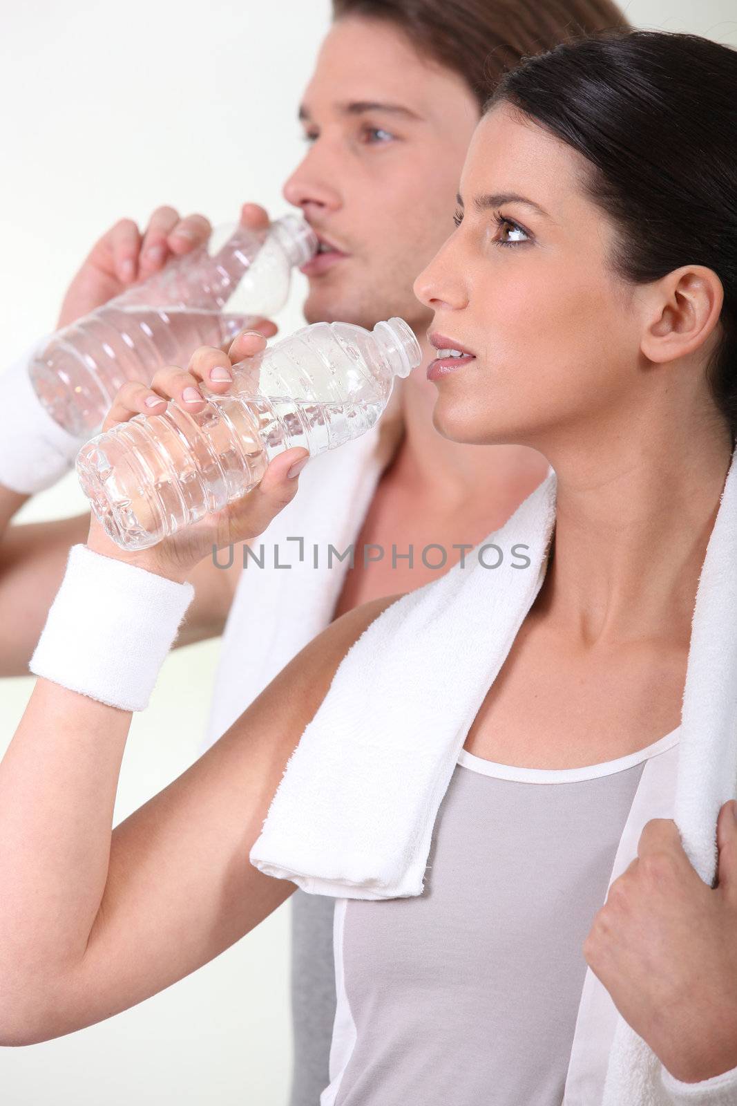 Sporty people drinking water by phovoir