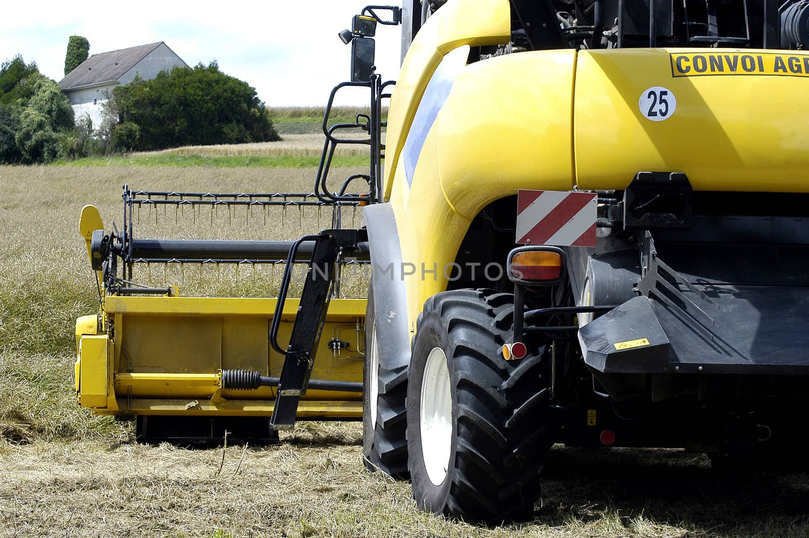 the harvest of colza with machines like a reaping-machine threshing-machine and tractor