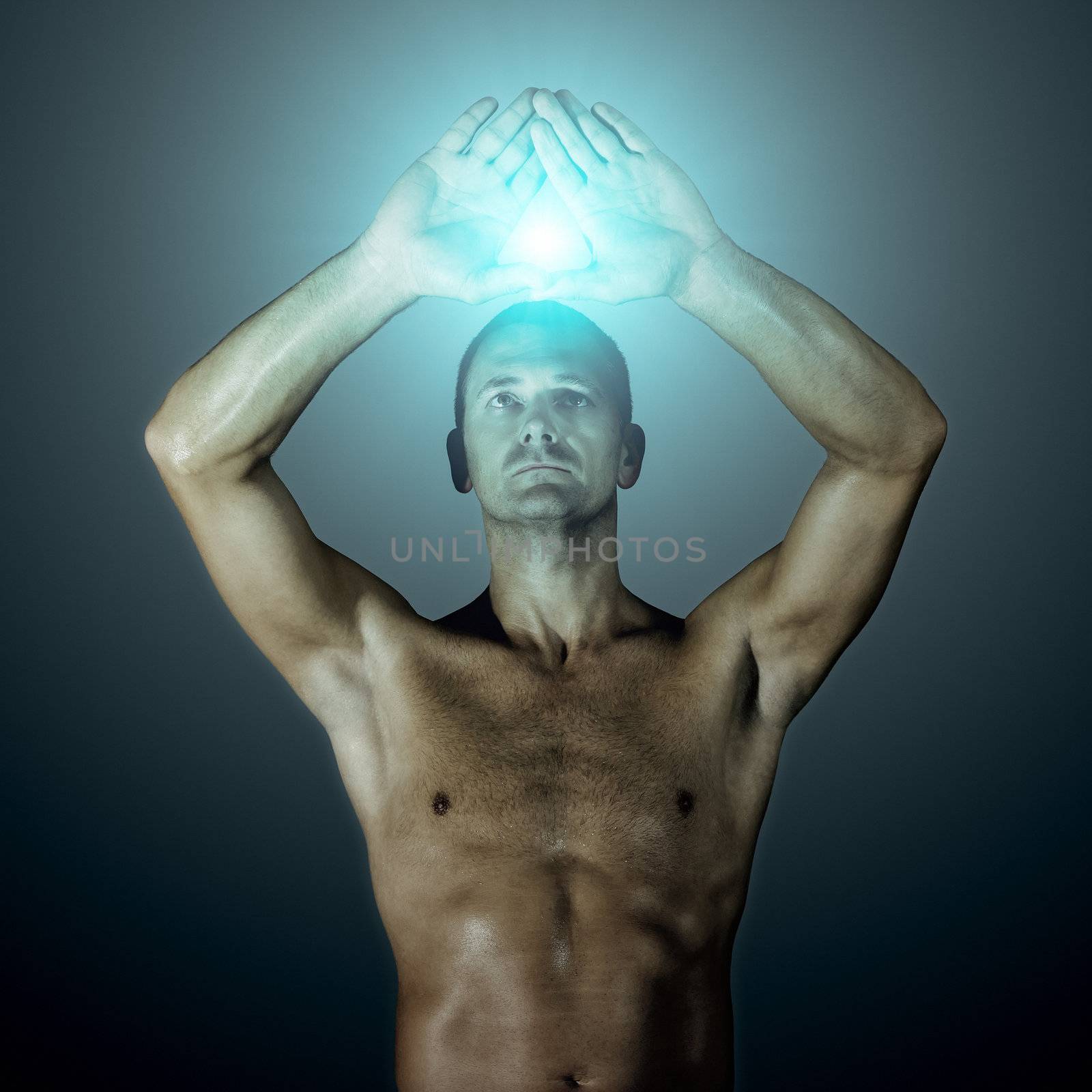 An image of a handsome man showing a triangle with his hands