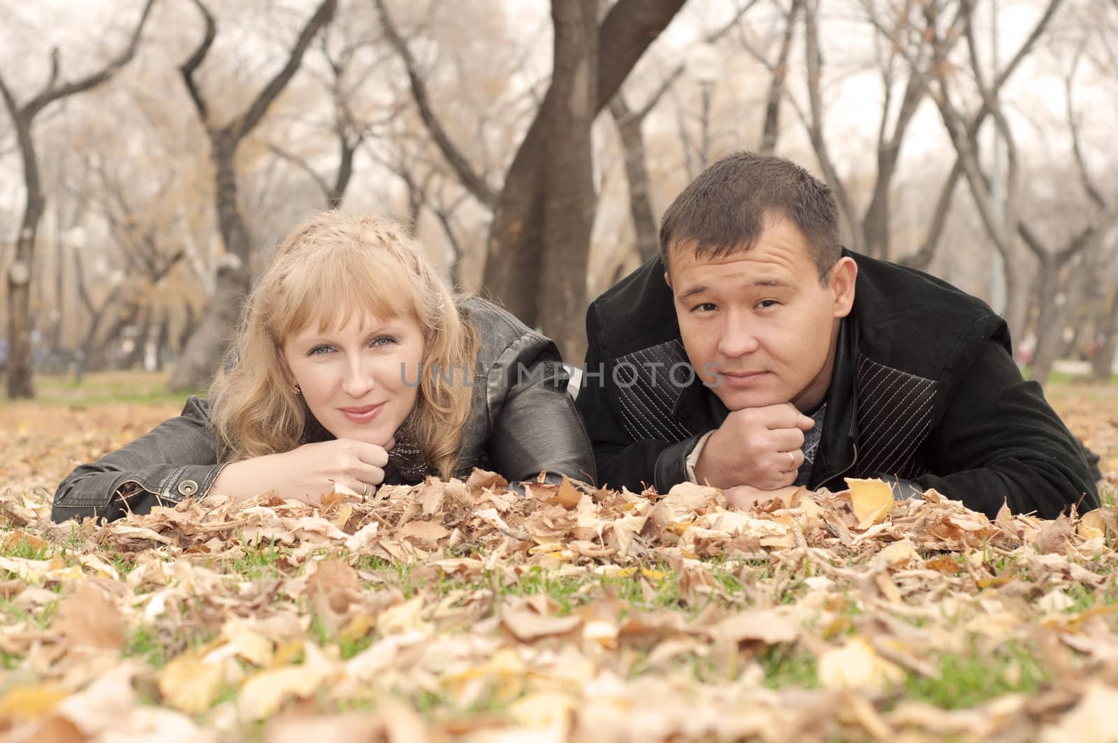 man and the woman lay together on a grass