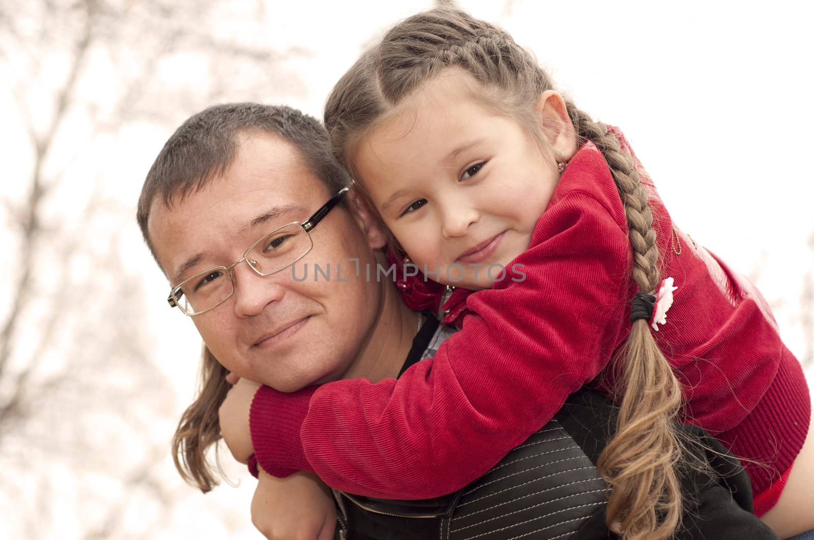 father playing with daughter, raised it high above them