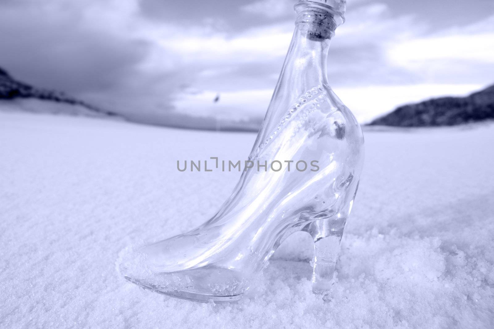 a glass slipper in a snow covered irish golf course for a concept on ladies golf