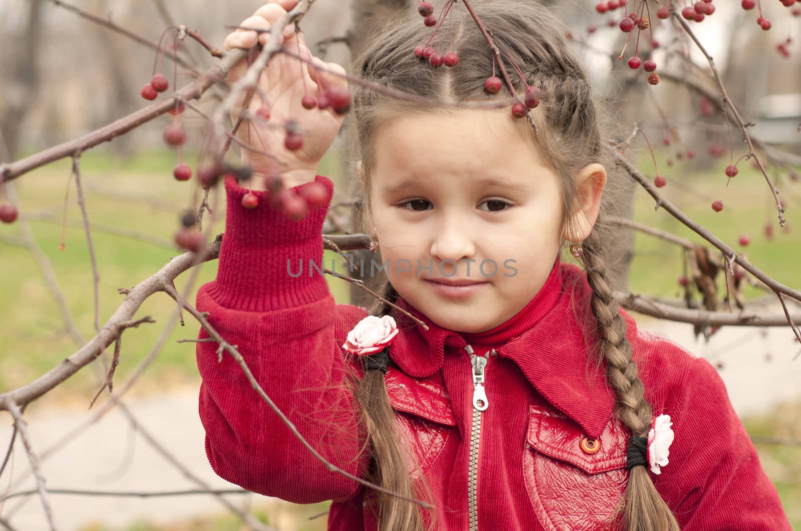  young girl in autumn park, in red coat