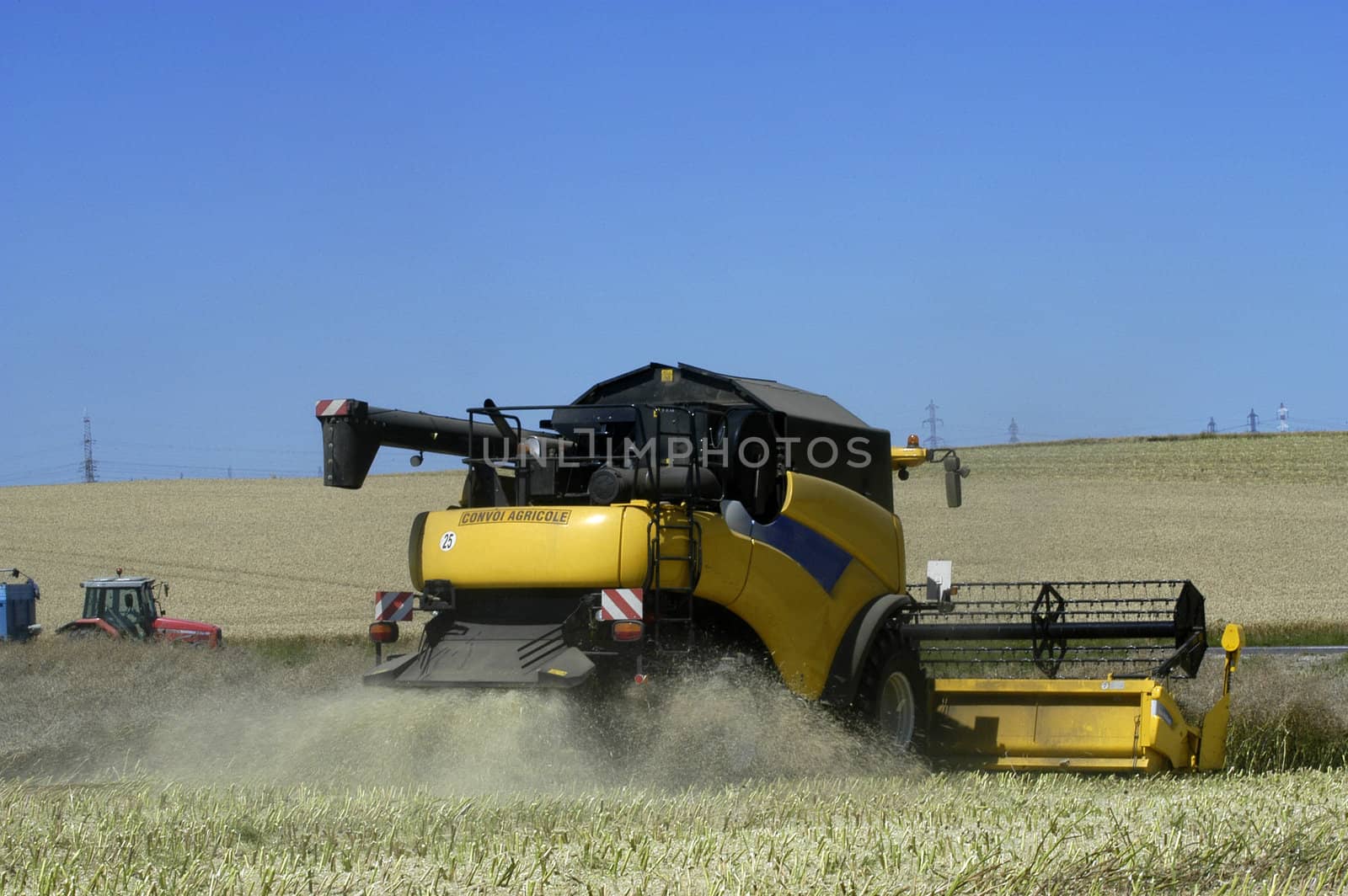 the harvest of colza with machines like a reaping-machine threshing-machine and tractor