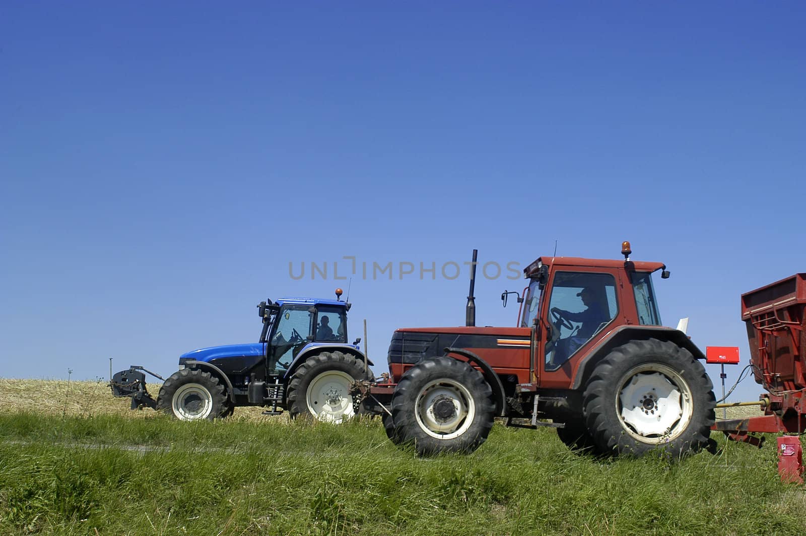 the harvest of colza with machines like a reaping-machine threshing-machine and tractor