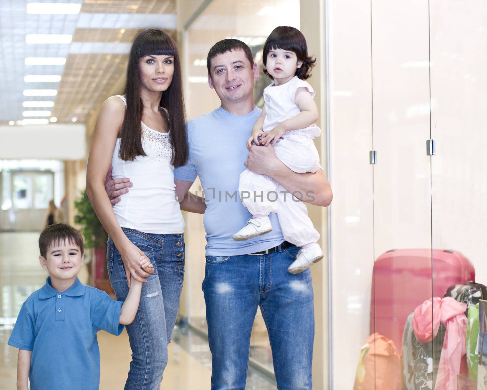 Mum and the son discuss purchases in shopping center