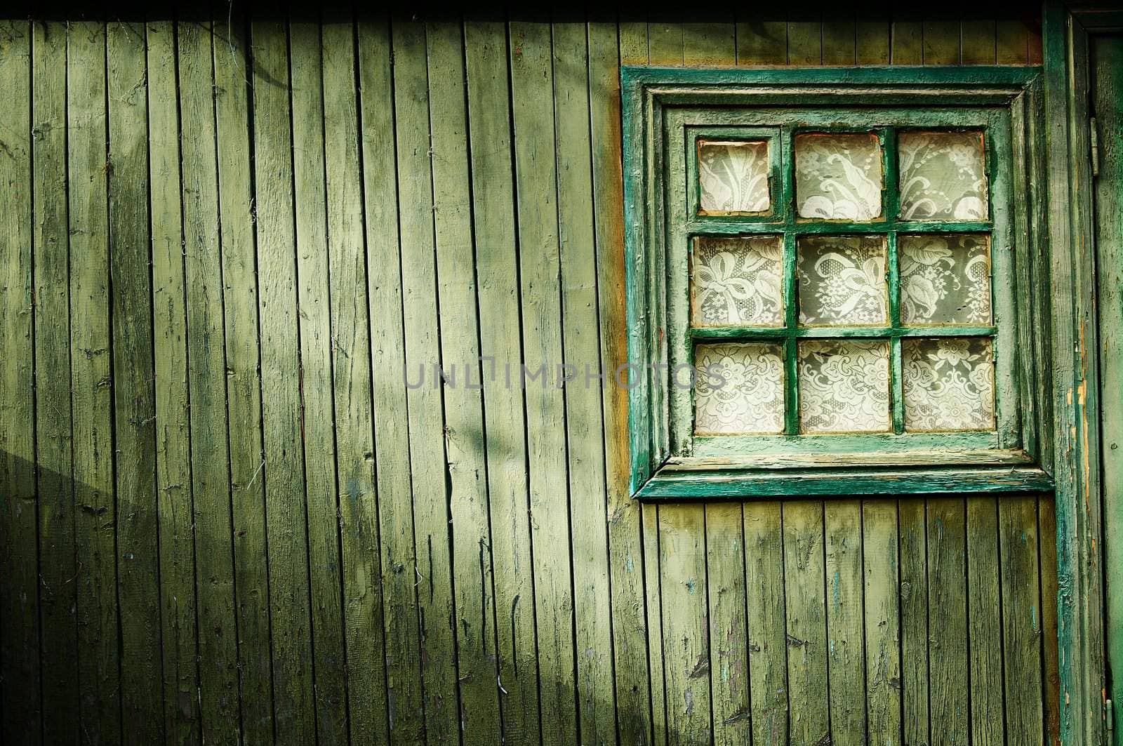 Wooden wall of green color, with a square window Vintage