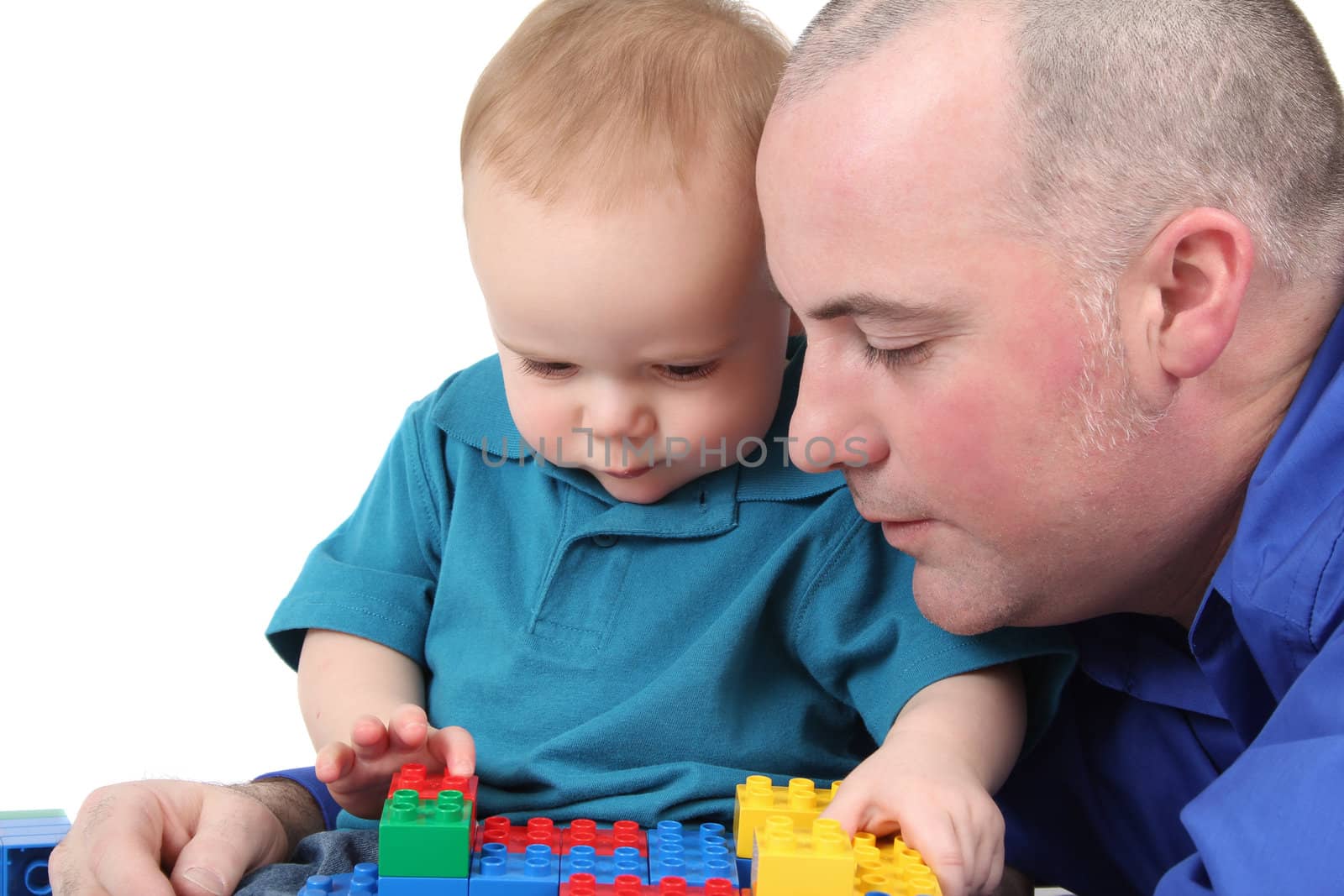 Father and son building with colorful blocks