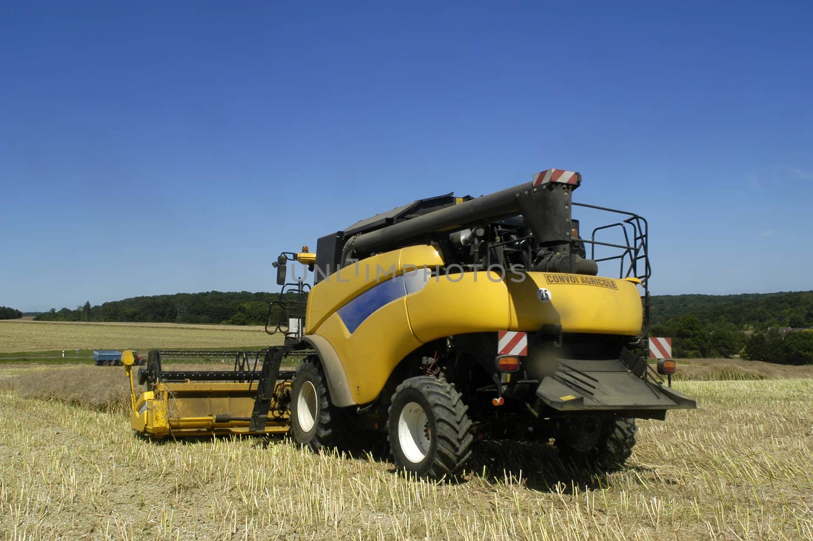 the harvest of colza with machines like a reaping-machine threshing-machine and tractor