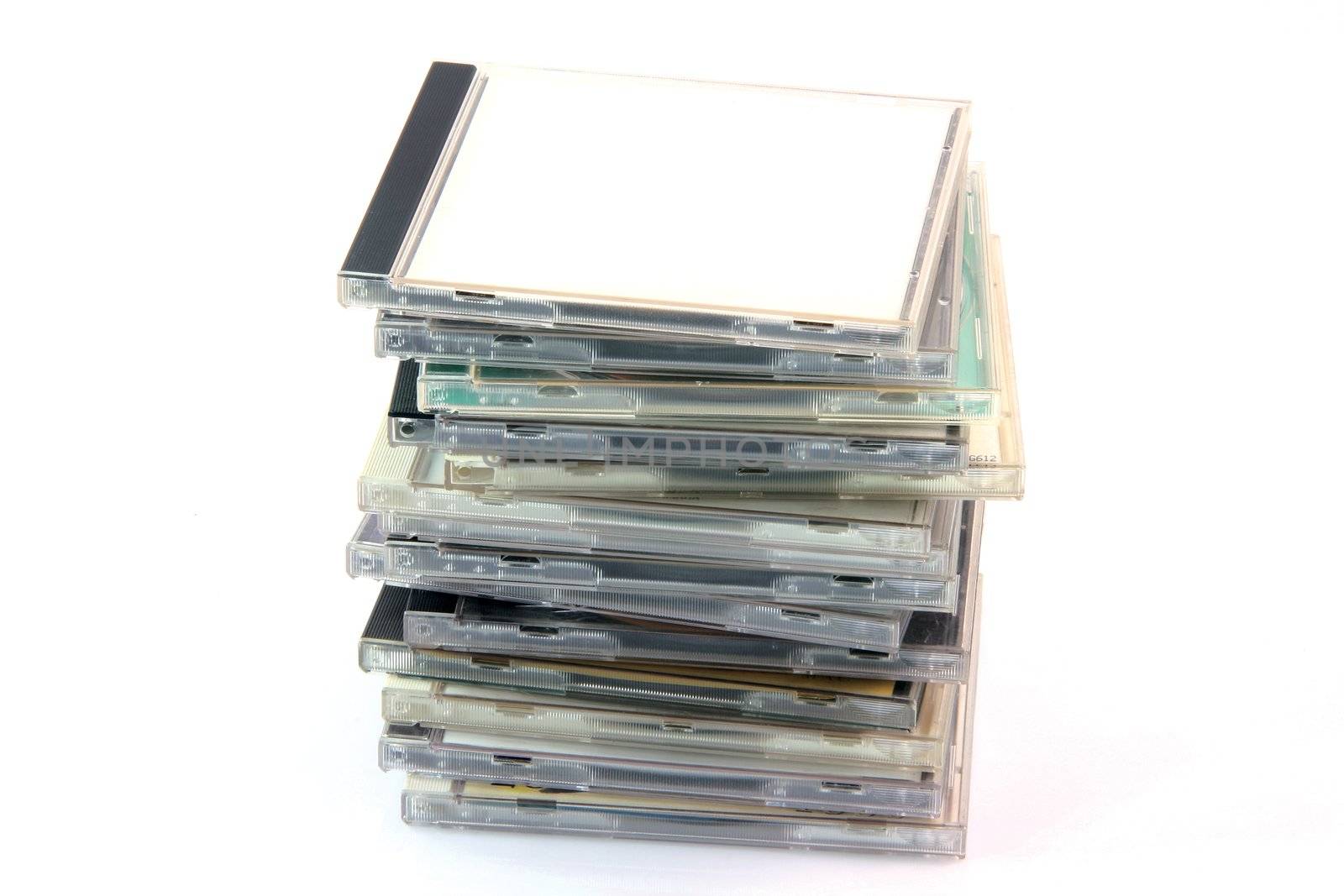 pile of cd cases isolated on white background and empty label to add your message