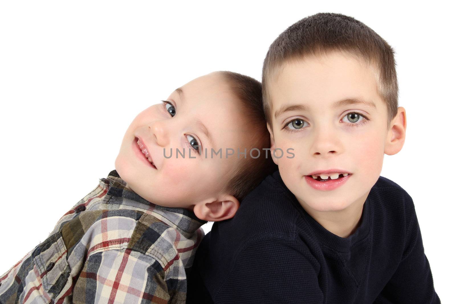 Two young brothers against a white background