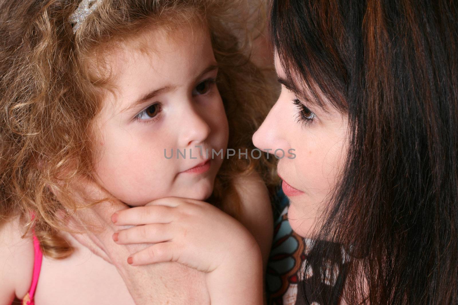 Beautiful mother and daughter against a brick wall background