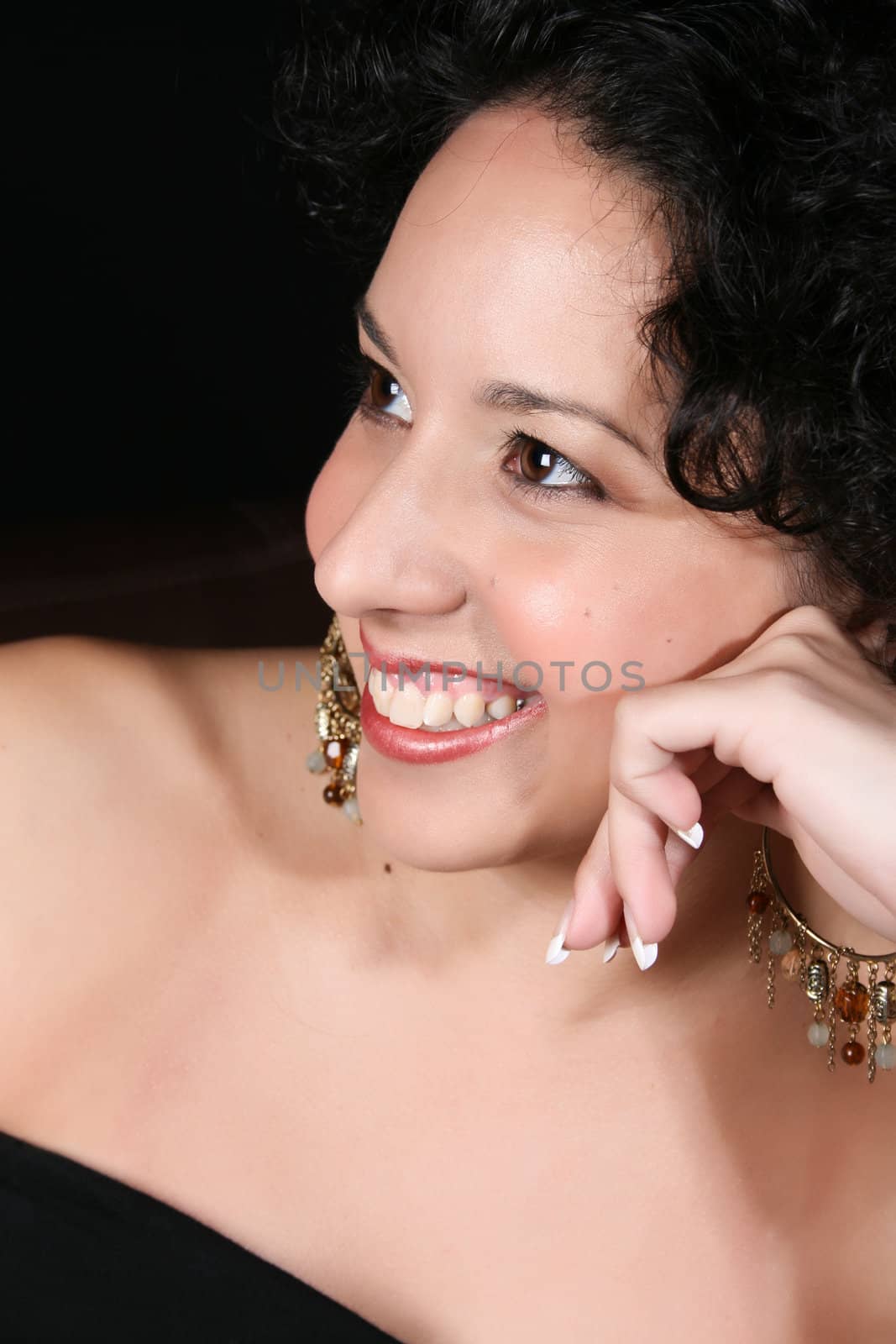 Young brunette female wearing beautiful beaded earrings 