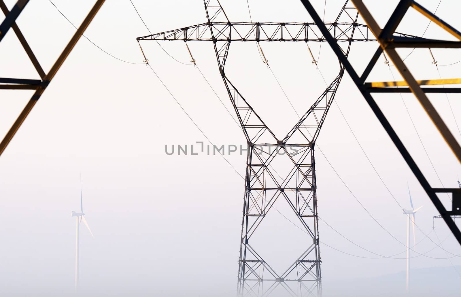 high voltage pylons and windturbines