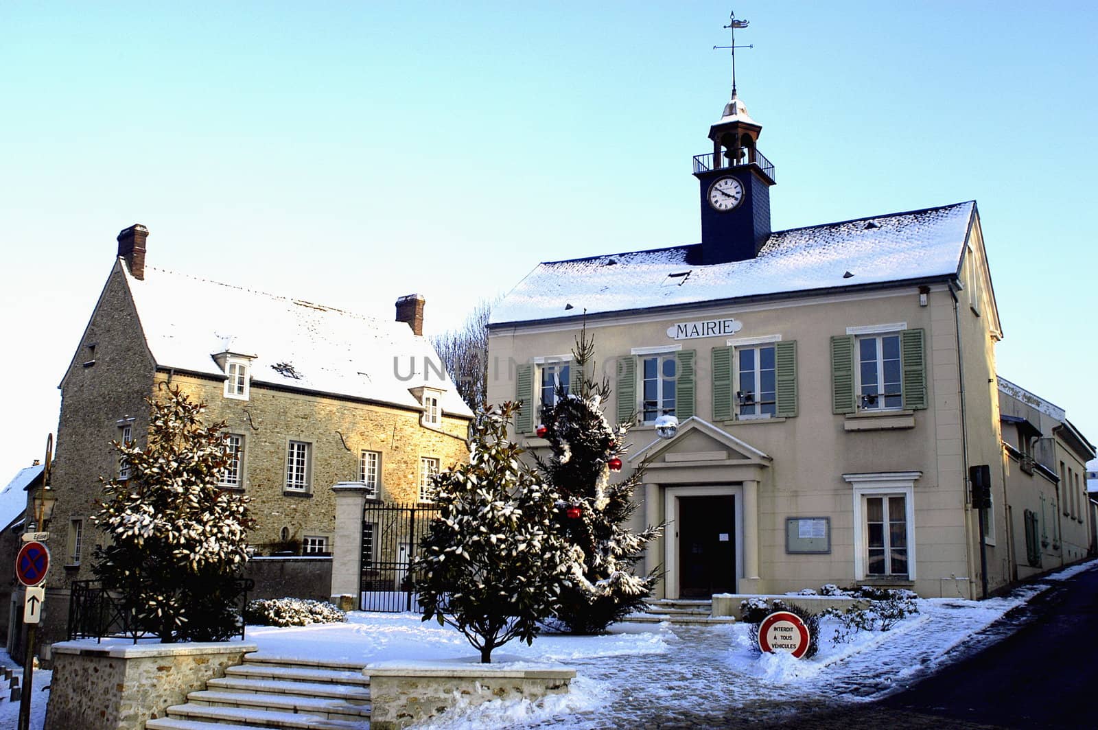 Town hall of Thoiry in winter under snow