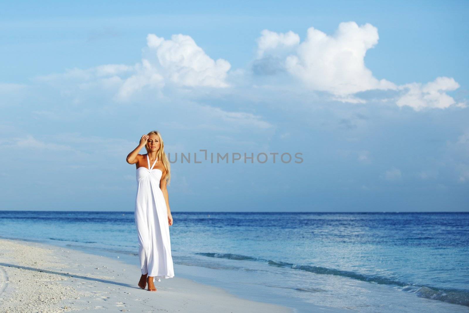 woman in a white dress on the ocean coast