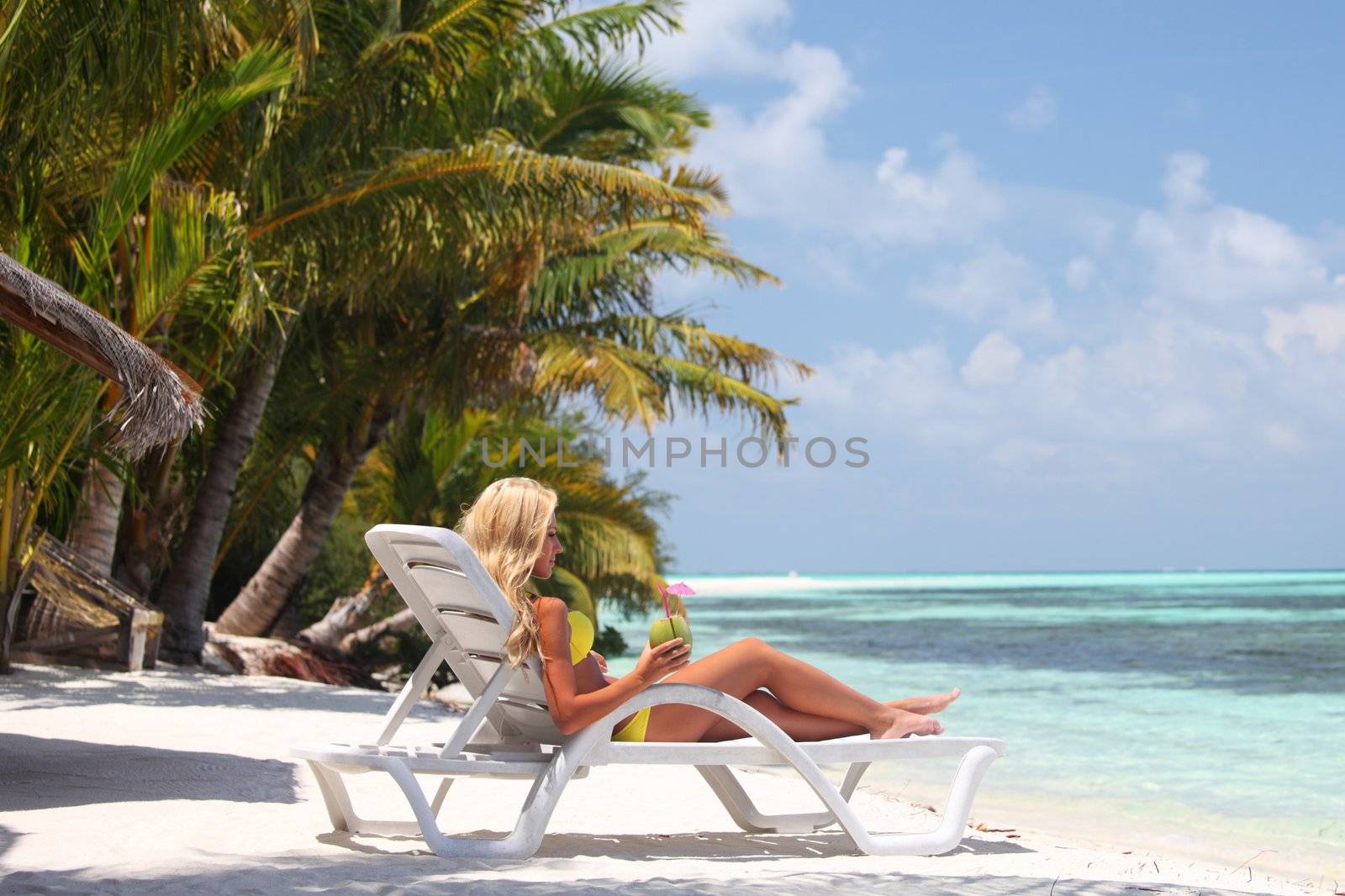 tropical woman on lounge by Yellowj
