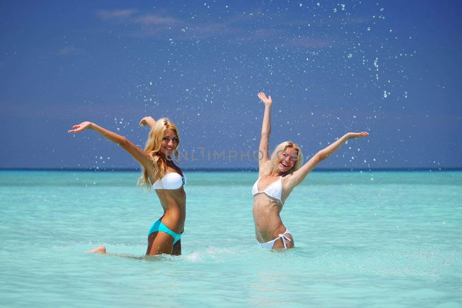 Two girls playing in ocean water