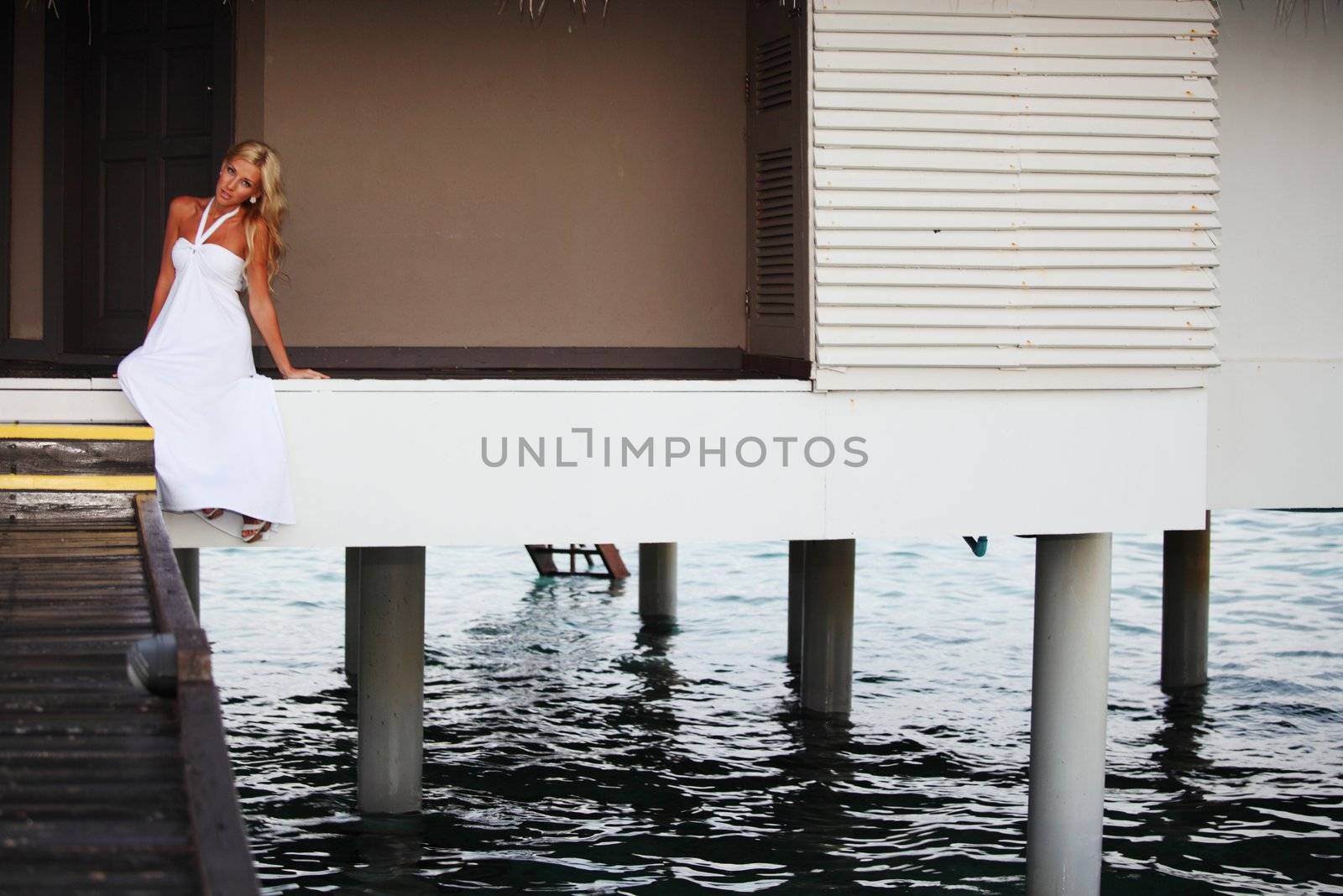 woman in a dress on a bridge home sea