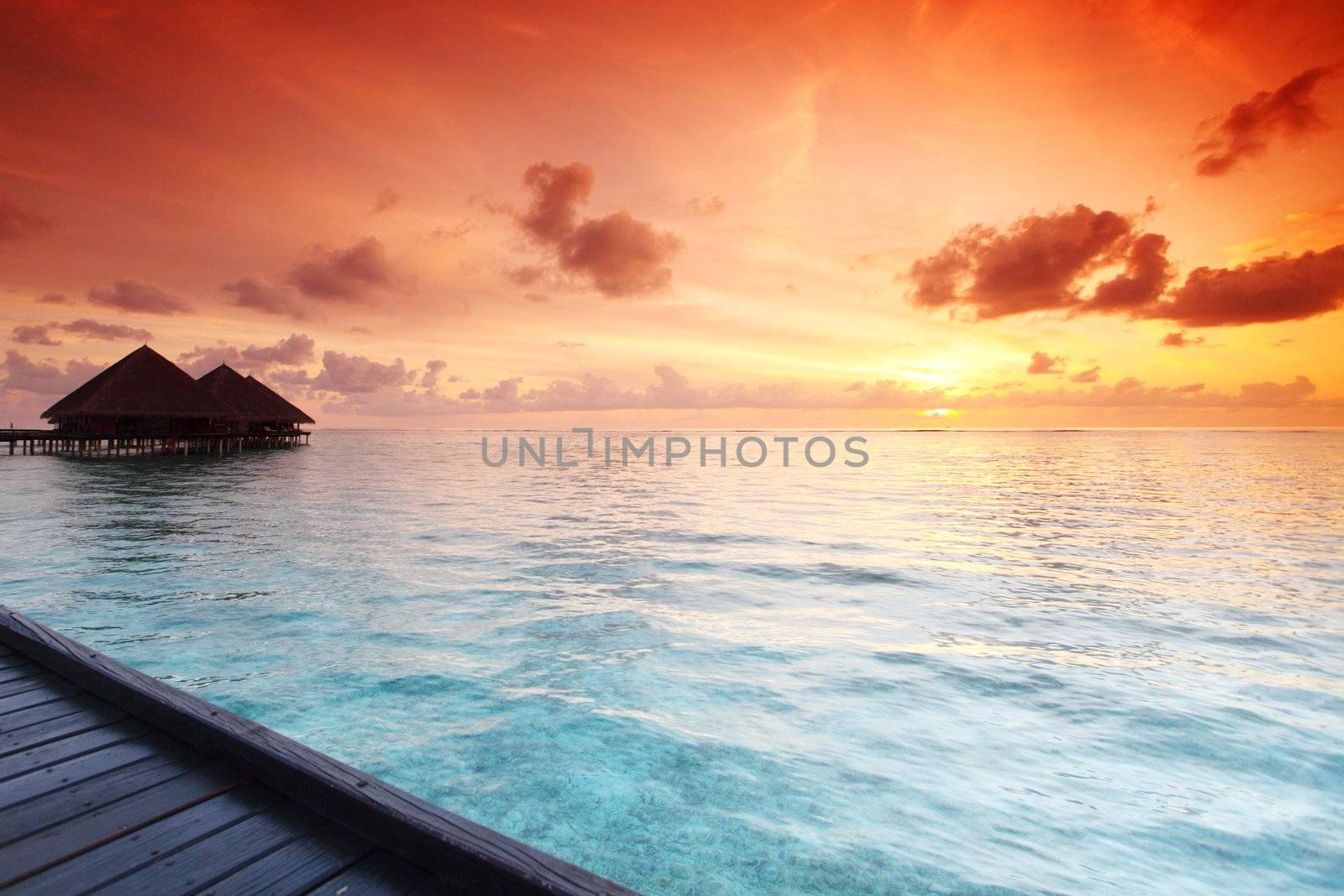resort maldivian houses on sunrise