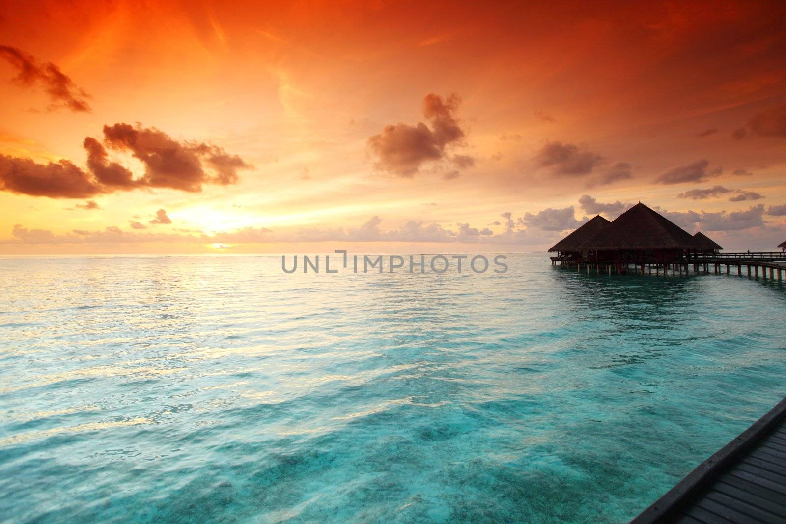 resort maldivian houses on sunrise