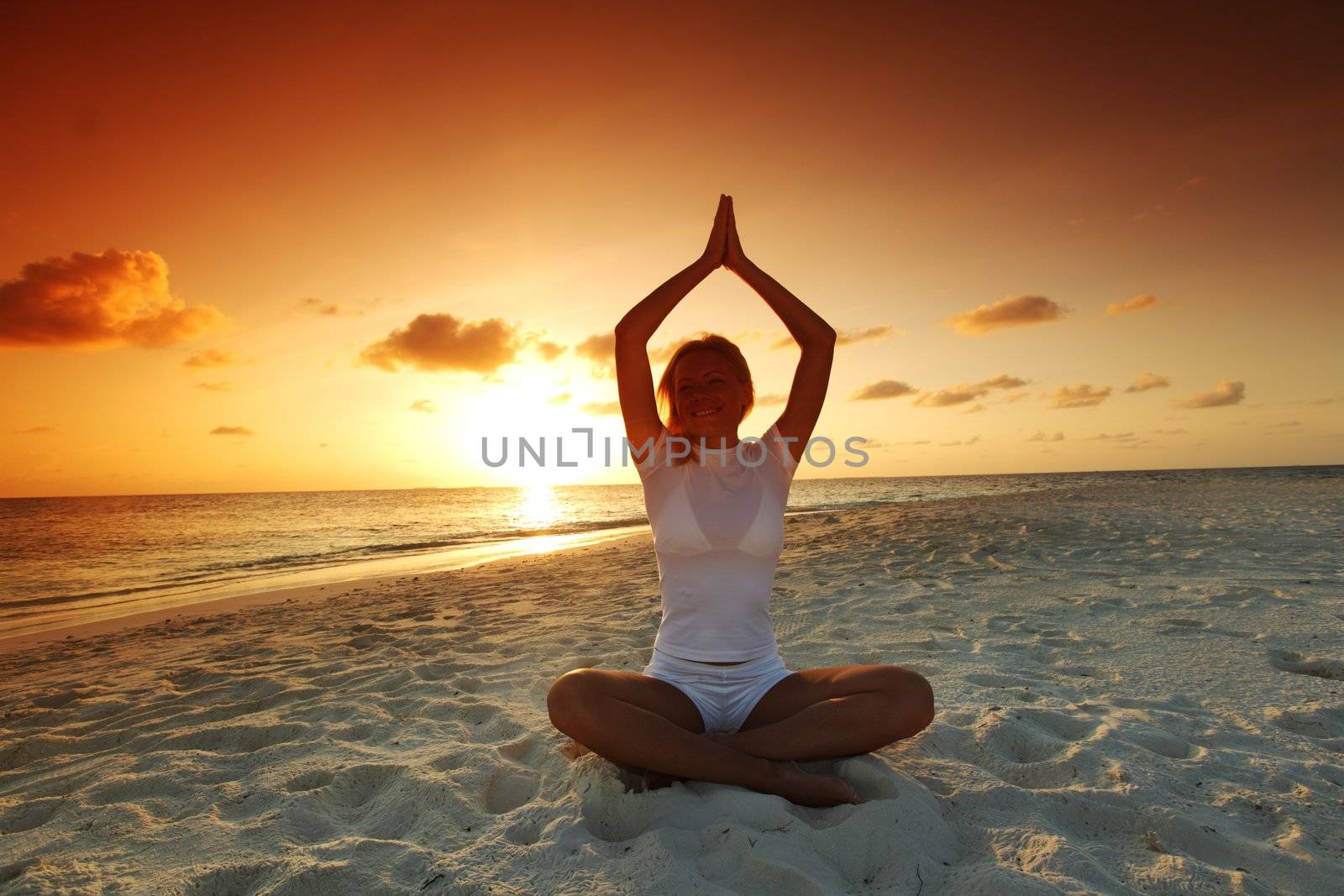 sunset yoga woman on sea coast