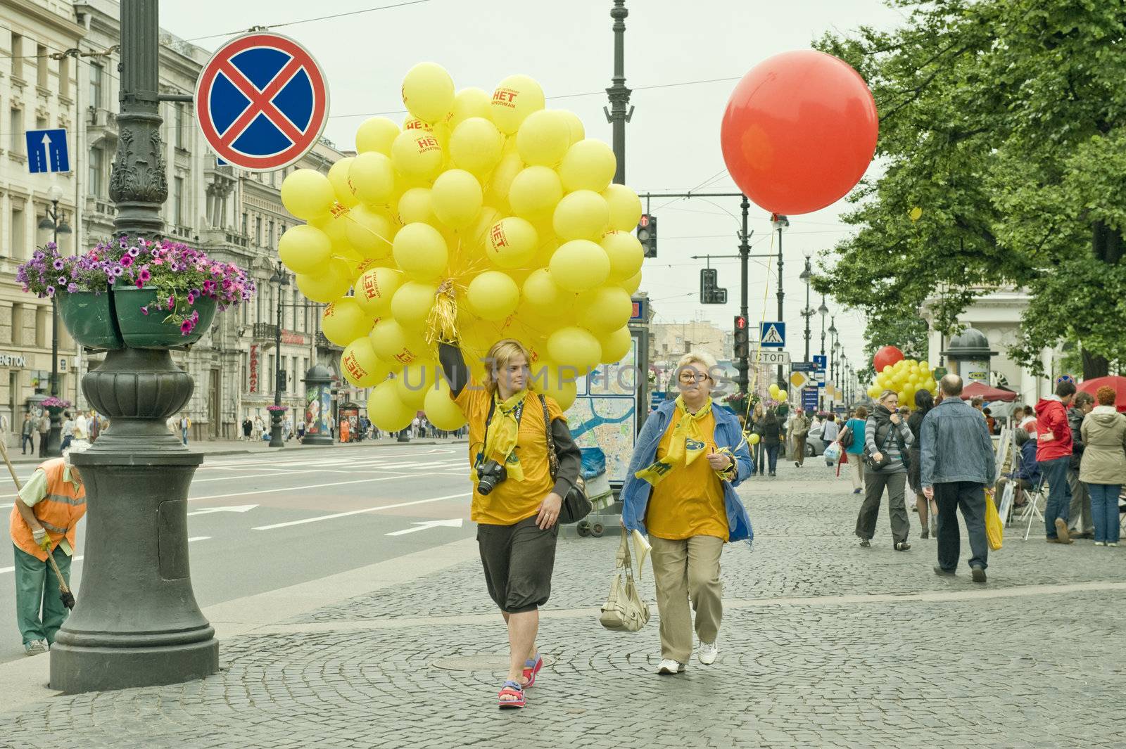 Two woman with yellow and re balloons, taken in St Petersburg, Russia.