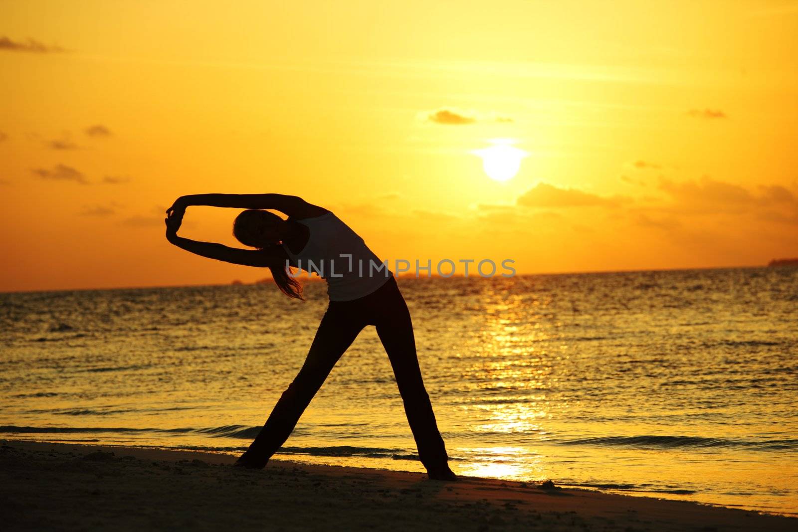 sunset yoga woman on sea coast