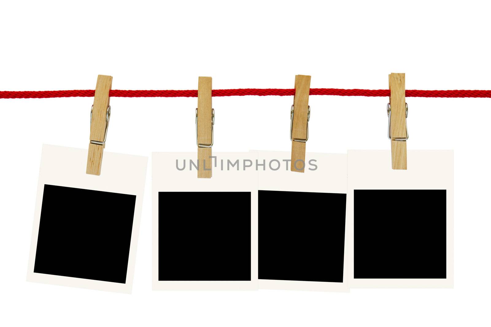 Blank photo frames hang by wooden peg on white background