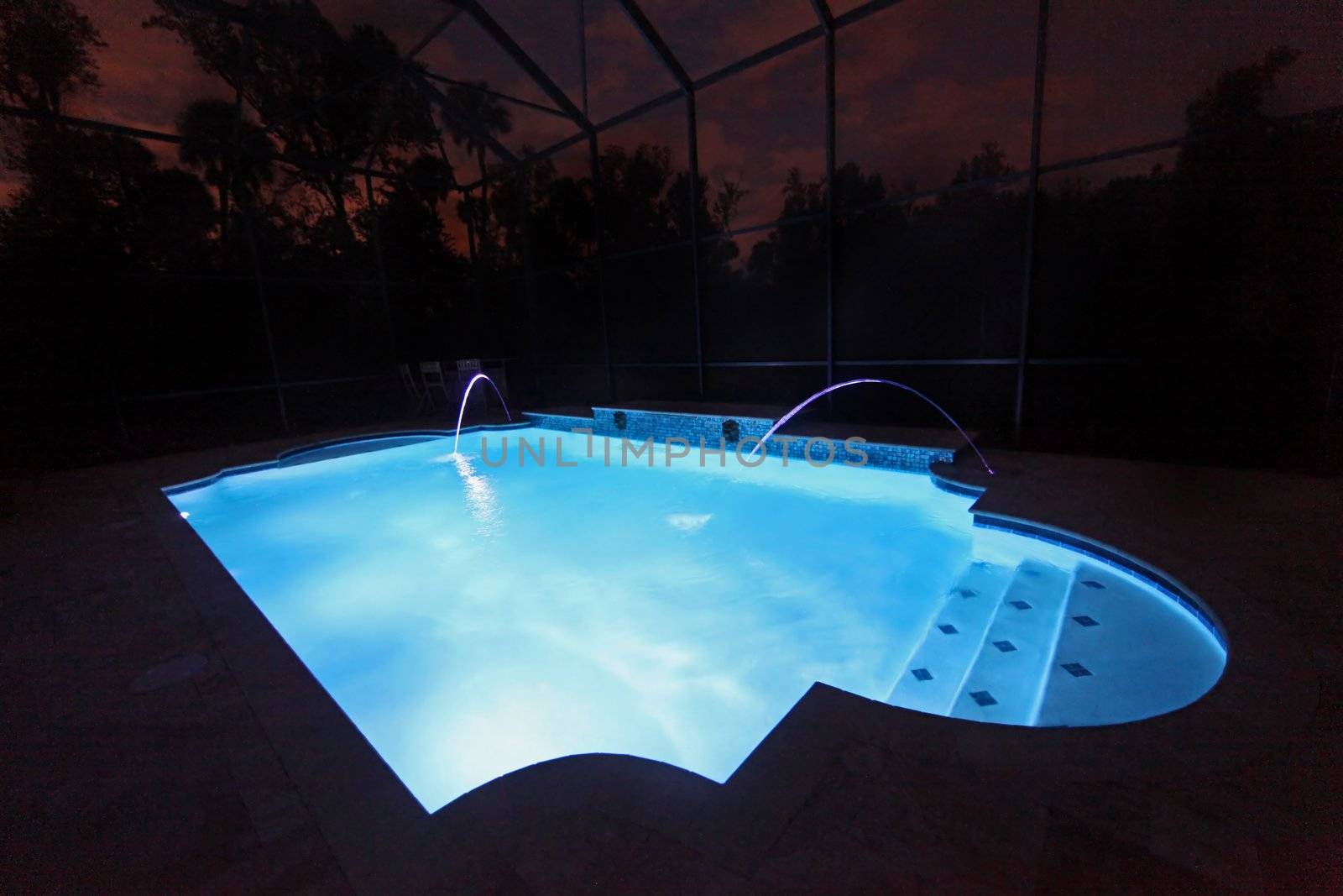 A Swimming Pool lit up at night