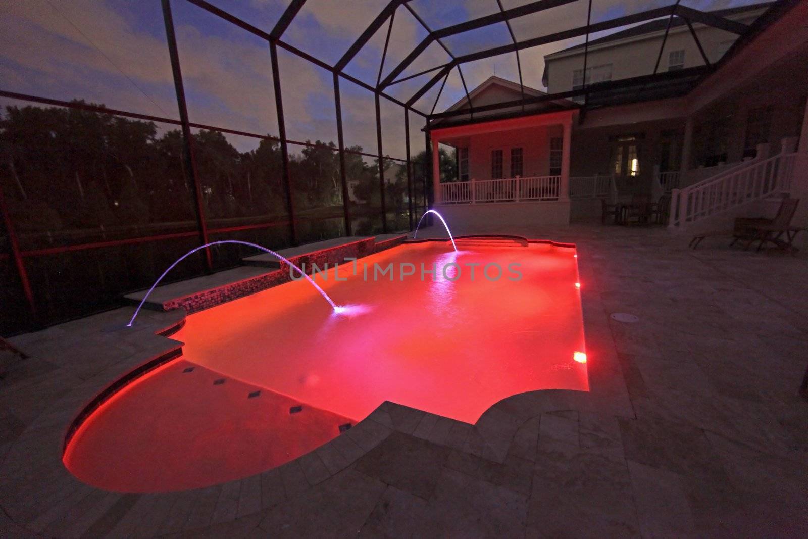 A Swimming Pool lit up at Night