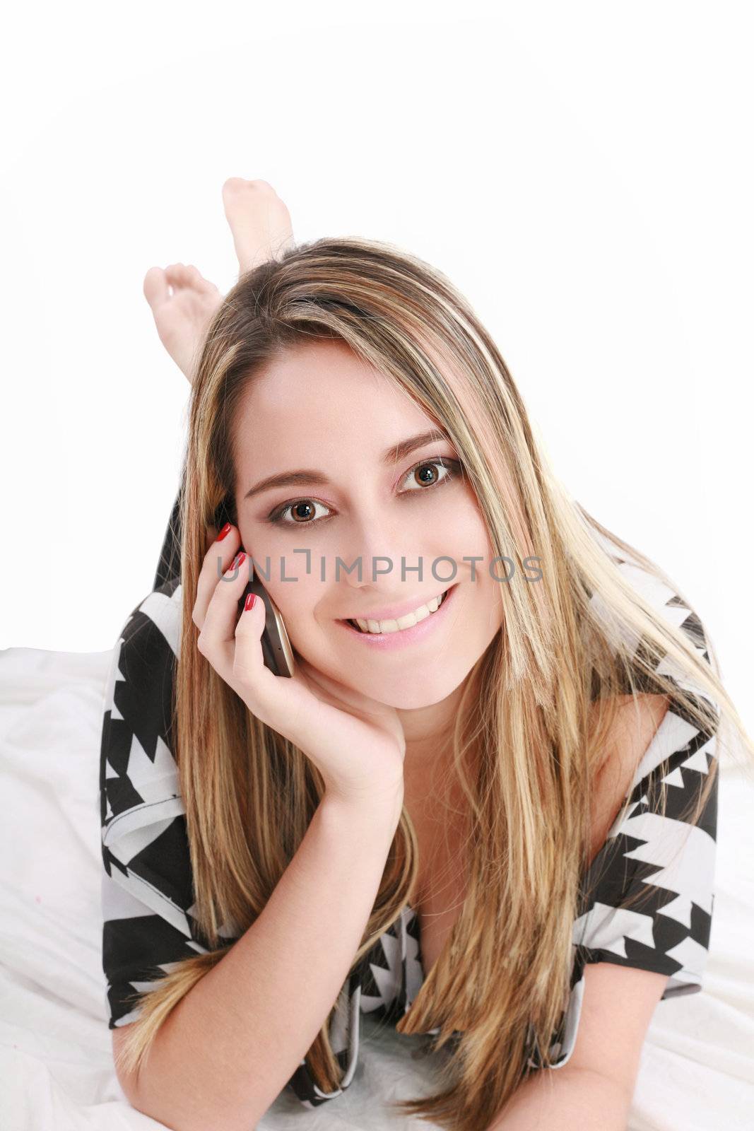 Attractive woman talking on phone lying on the floor at home by dacasdo