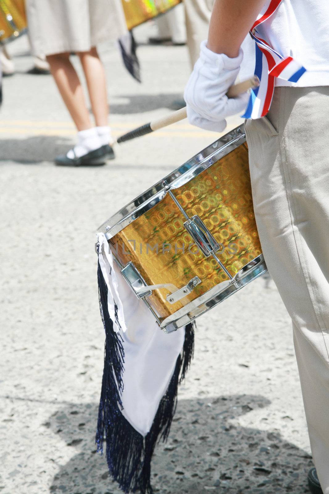 Drummer playing snare drums in parade, copy space, vertical
