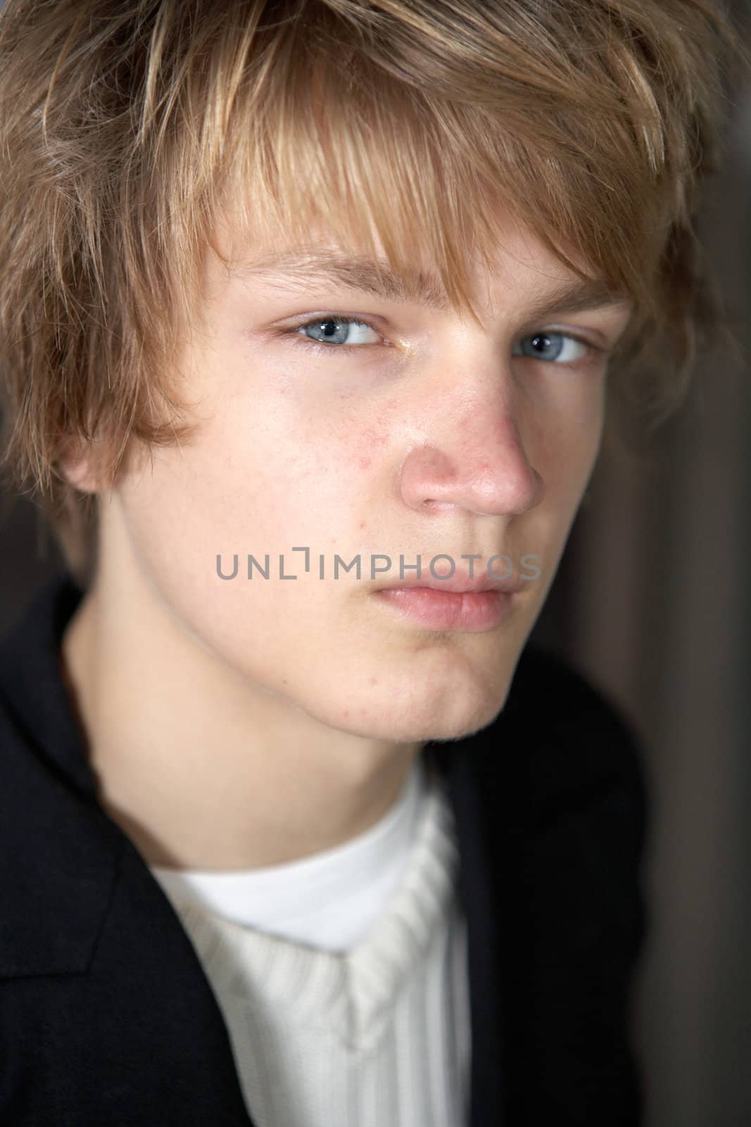 Close-up portrait of teenage boy, vertical composition