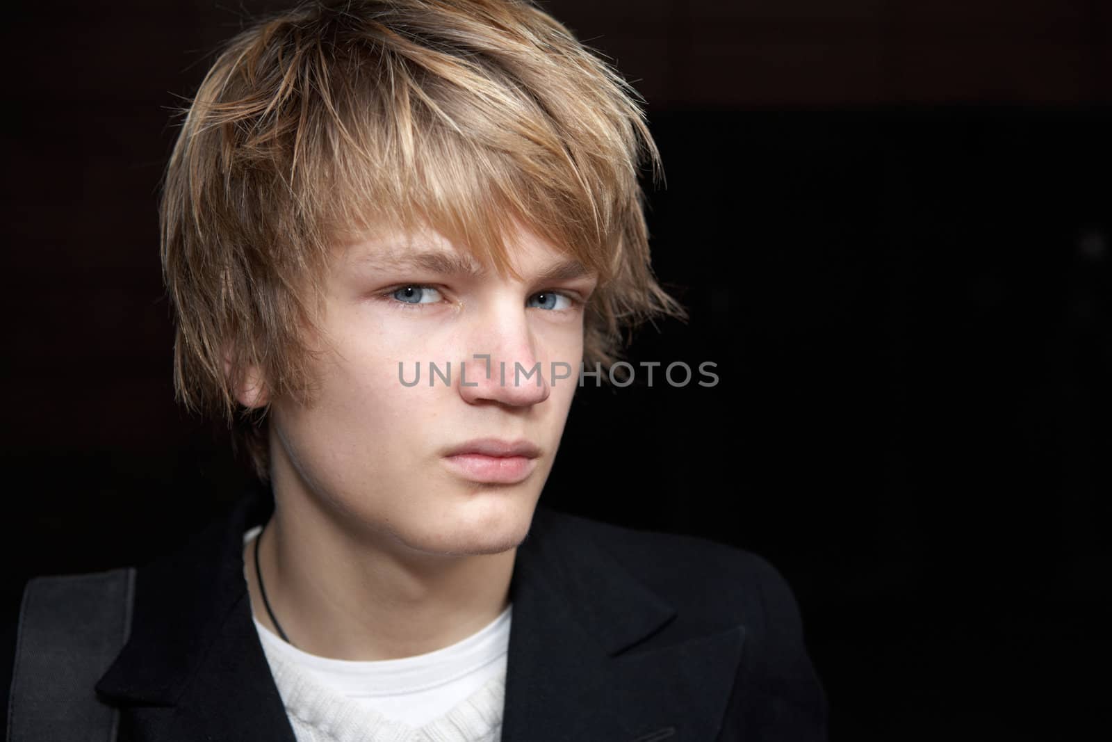 Portrait of teenage boy in street, close-up