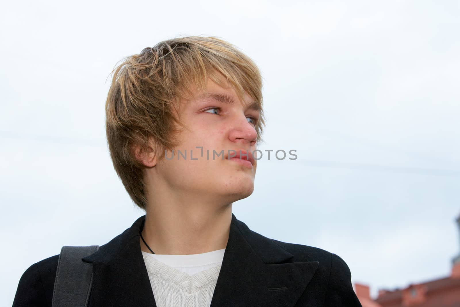 Portrait of teenage boy in street, low angle view