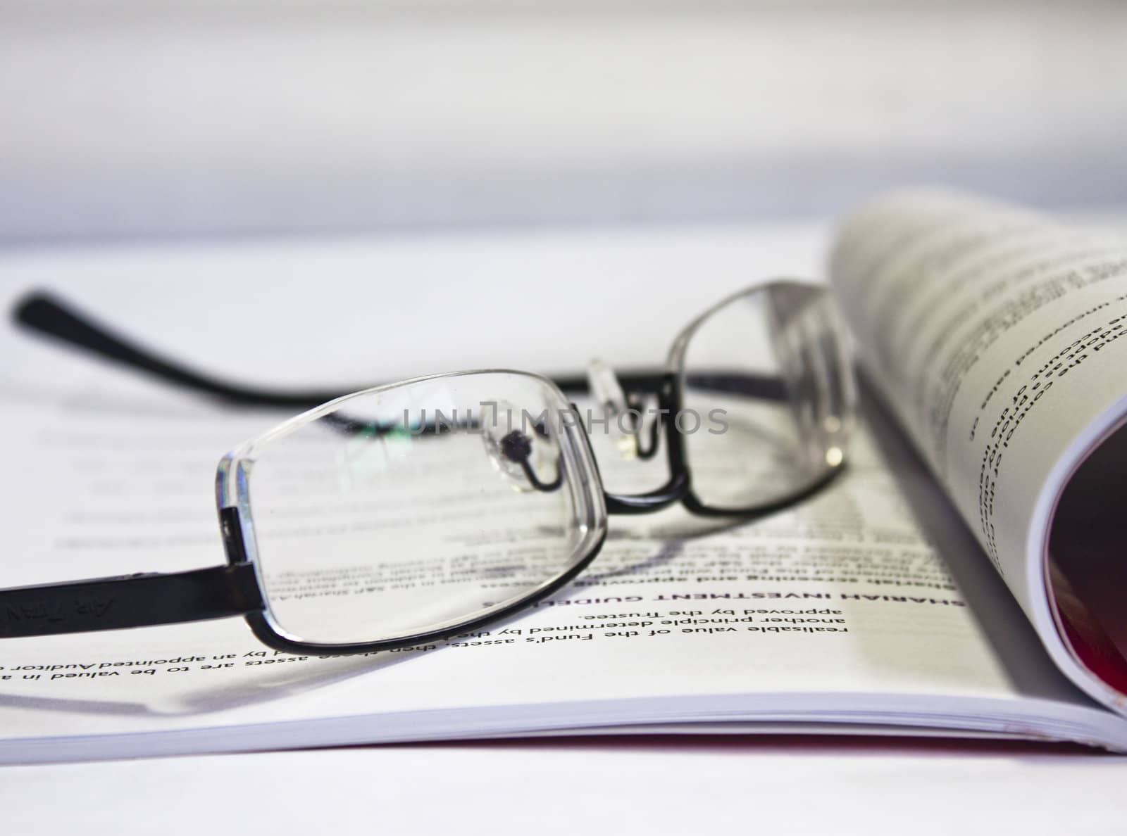 Reading Glasses on Book by Sukha