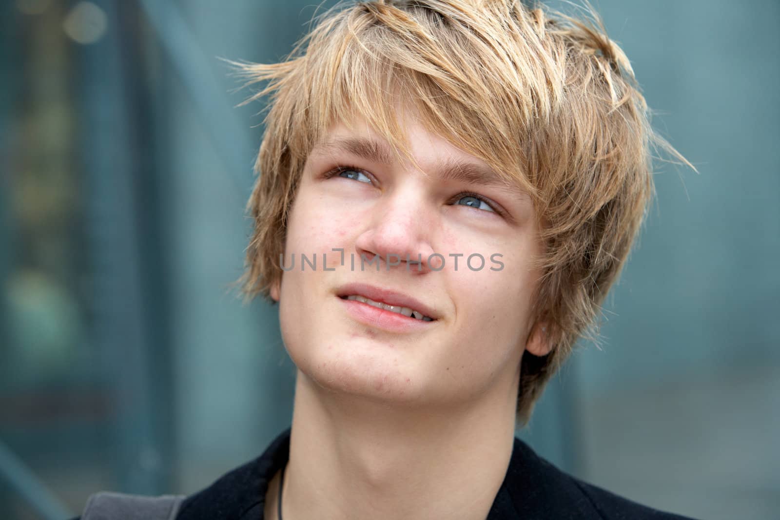 Close-up of teenage boy smiling in urban environment