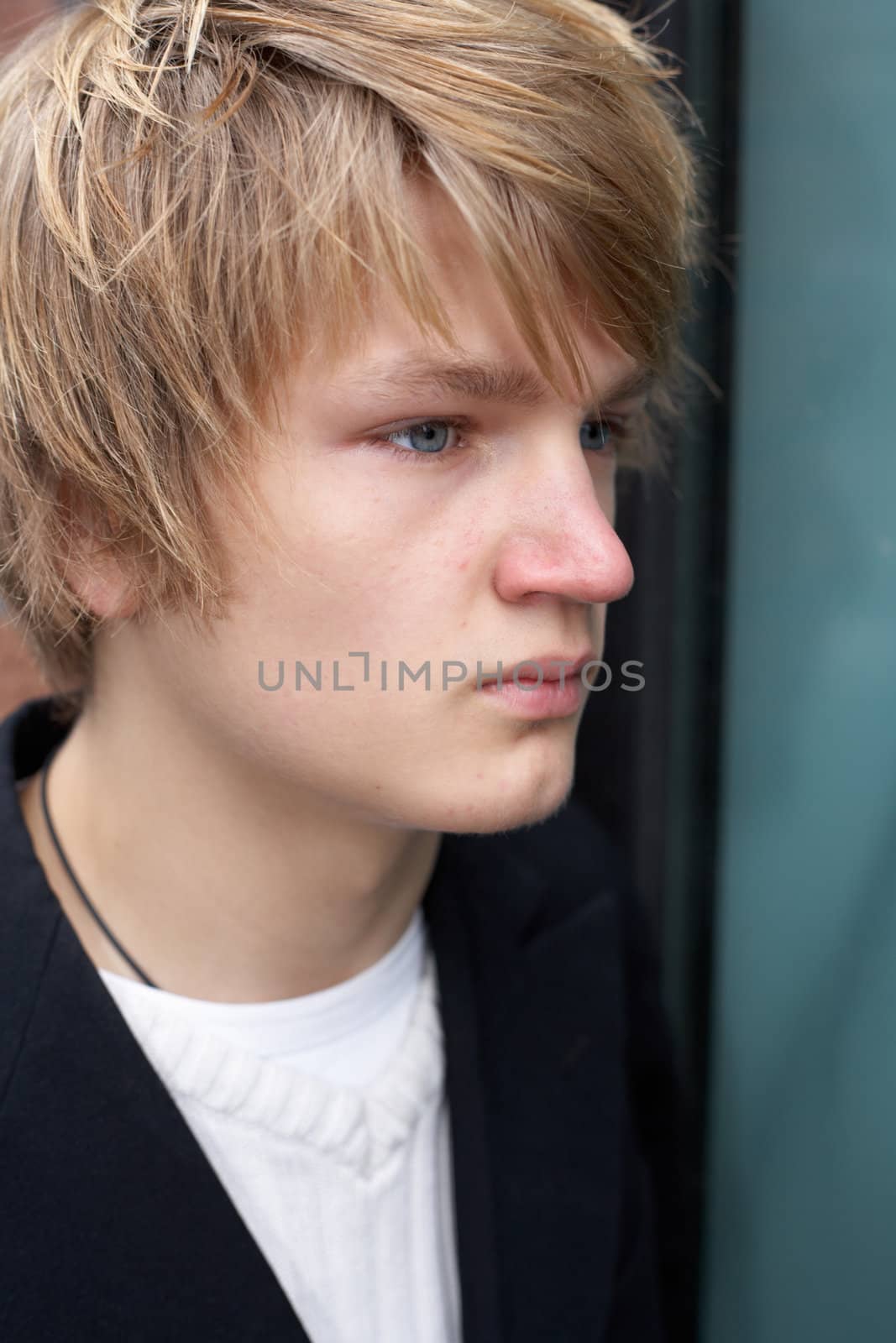 Portrait of thoughtful young teenager outdoors