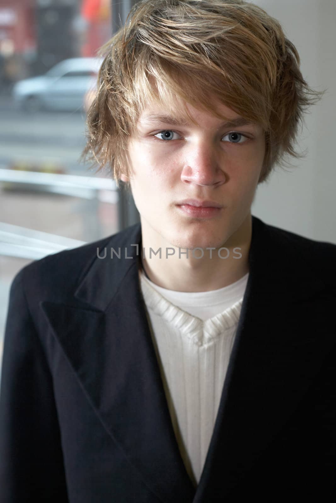 Portrait of teenage boy in urban environment, interior