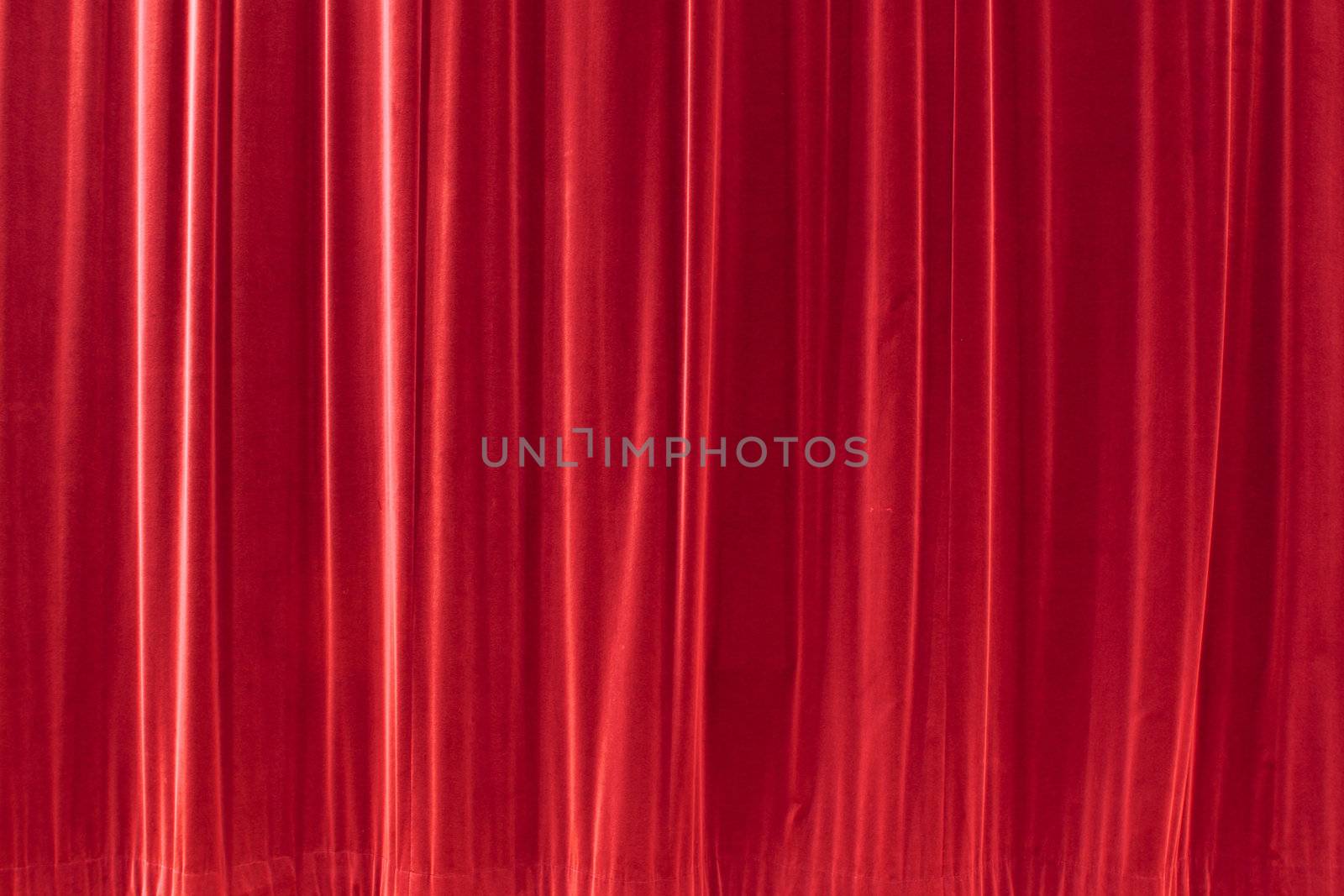 red background texture that looks like a silky fabric or curtain. This tiles seamlessly as a pattern. 