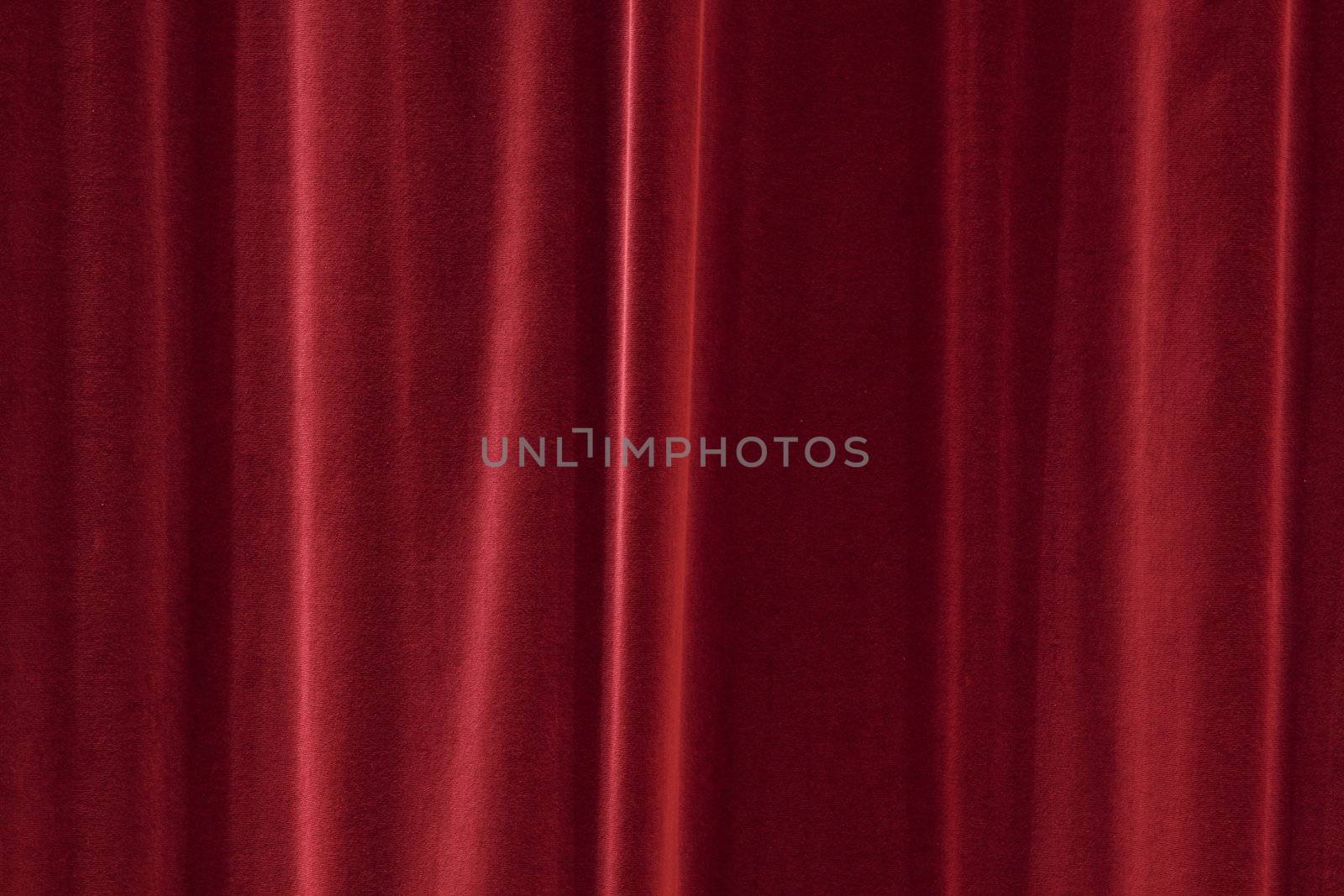 red background texture that looks like a silky fabric or curtain. This tiles seamlessly as a pattern. 