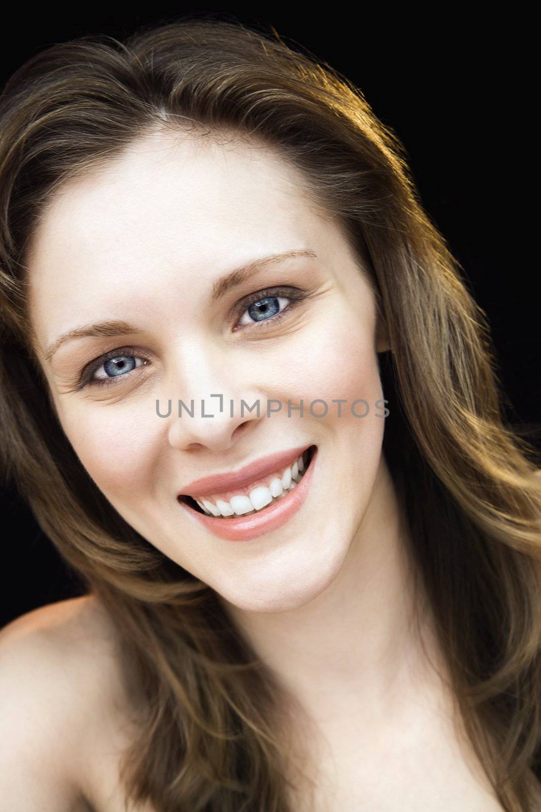 Close up portrait of young adult caucasian female smiling.