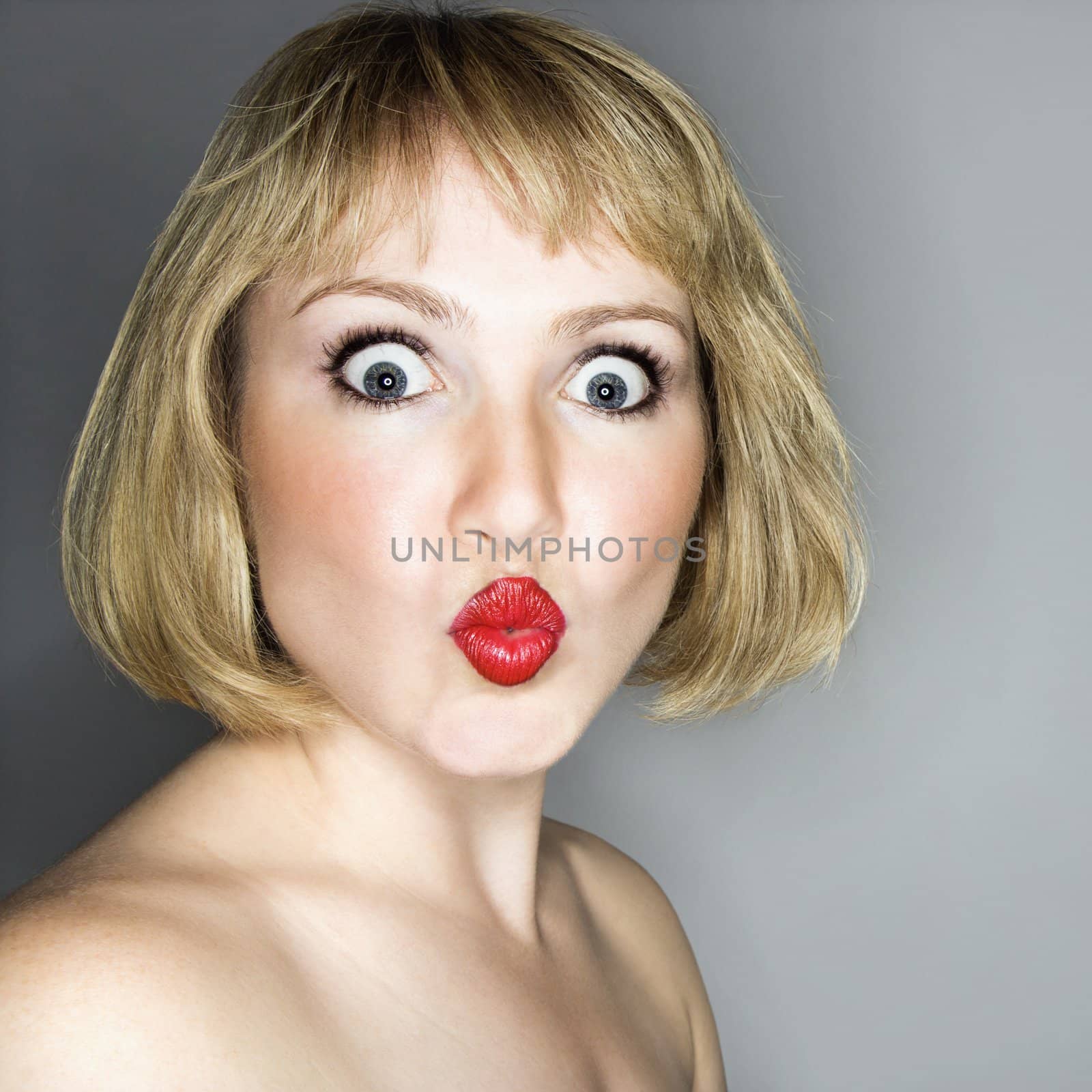 Woman looking surprised. by iofoto