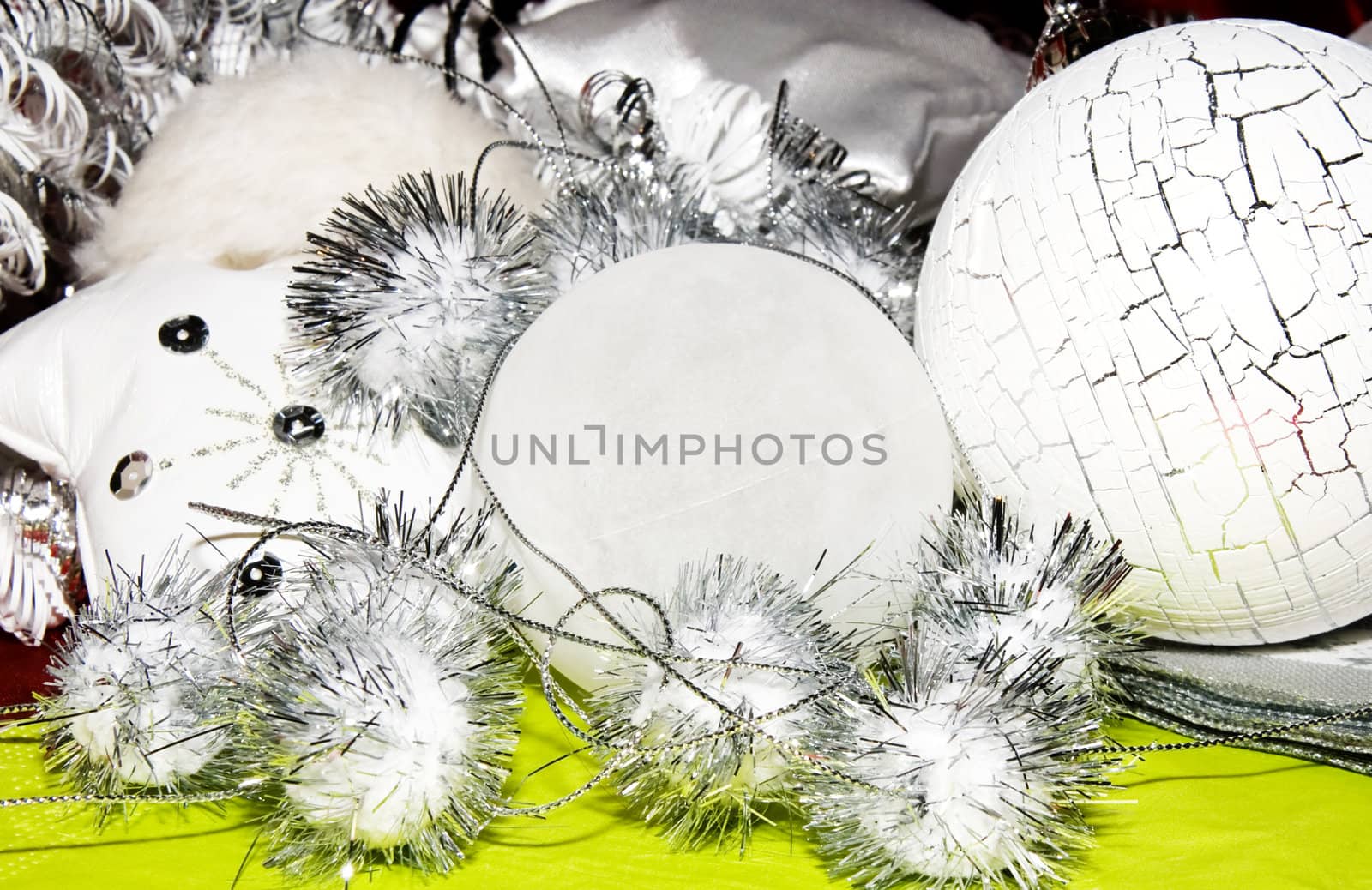 white and silver  christmas decoration on green forground 