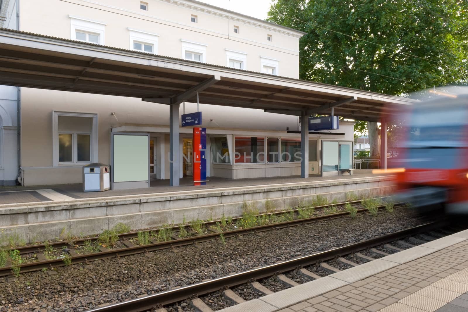 Small railway station with a moving train