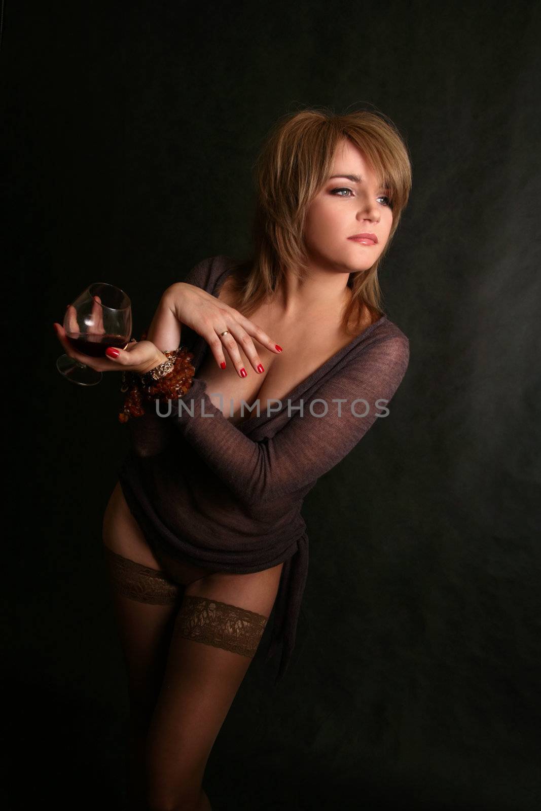 Portrait of the fine woman with a glass of cognac